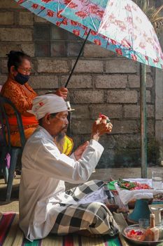 alinese Brahman performing morning rituals in the Bali temple, Indonesia.