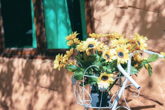 Flower on basket of bike with decoration at home stay.