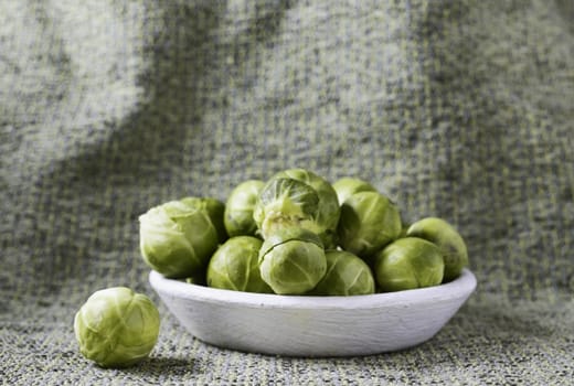 Brussels sprouts on white plate ,beautiful green leaf vegetables 