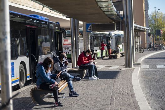 terni,italy november 03 2020:people at the station wait for the bus with a medical mask due to corona virus