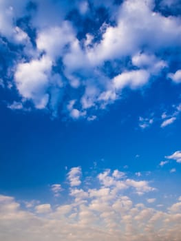 White fluffy clouds in the blue sky with morning light from the sunrise