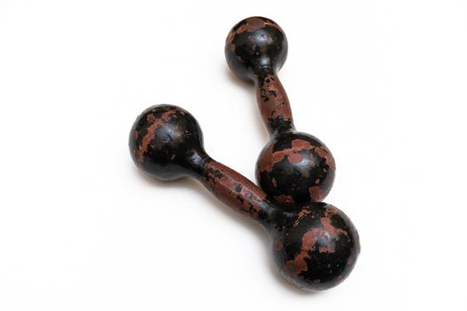 Pair of old sports dumbbells for strength training on white background