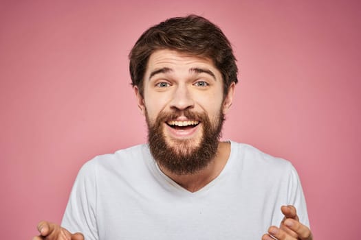 cheerful bearded man white t-shirt emotions cropped view pink background. High quality photo