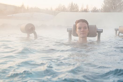 relax in termalnix spa, woman in swimming pool in winter.