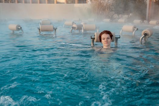 relax in termalnix spa, woman in swimming pool in winter.