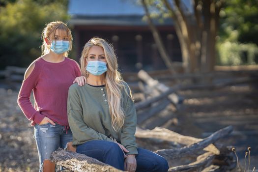 A mother and daughter enjoy a day outdoors while wearing masks and maintaining a safe distance from others during the Covid-19 pandemic