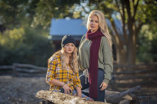 A beautiful young mother and her daughter enjoy the fall weather