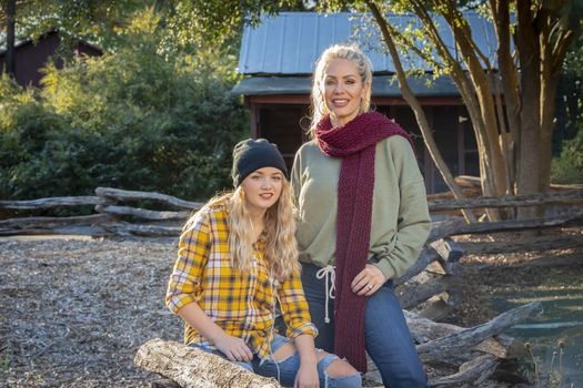 A beautiful young mother and her daughter enjoy the fall weather