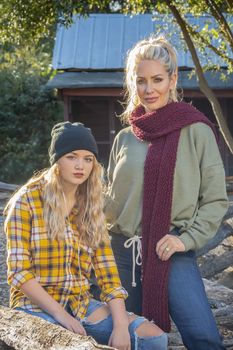 A beautiful young mother and her daughter enjoy the fall weather