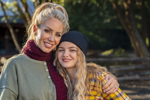 A beautiful young mother and her daughter enjoy the fall weather