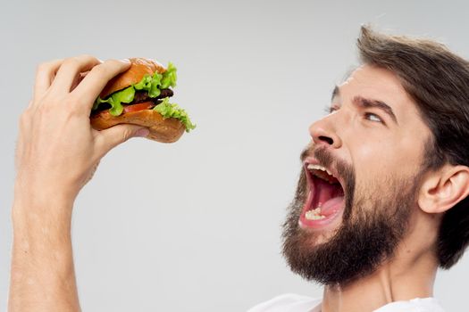 Man with hamburger fast food diet wide open mouth lifestyle