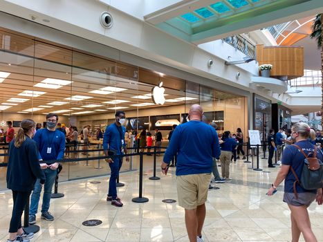 Orlando, FL/USA - 10/25/20: People waiting in line at the Apple retail store to look at and possibly purchase the new iPhone 12 and 12 Pro smartphones in Orlando, Florida.