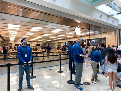 Orlando, FL/USA - 10/25/20: People waiting in line at the Apple retail store to look at and possibly purchase the new iPhone 12 and 12 Pro smartphones in Orlando, Florida.