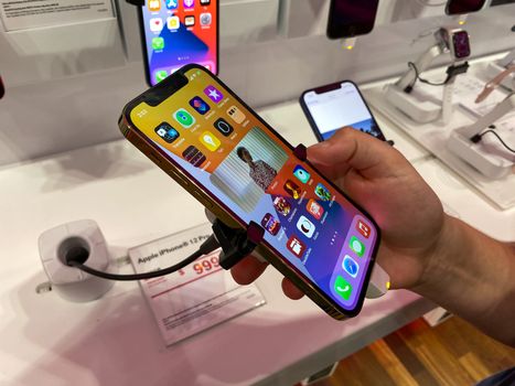 Orlando, FL/USA - 10/25/20: A person trying out the new Apple iPhone 12 Pro on display at the T Mobile store.