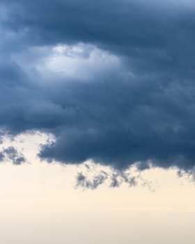 Dark blue heavy storm clouds before a thunderstorm or hurricane. Dramatic clouds in overcast weather. Cloudscape.