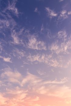 Colorful orange-purple dramatic clouds lit by the setting sun against the evening sunset sky. Cloudscape.