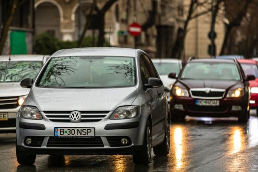 Car traffic at rush hour in downtown area of the city during a rainy day. Car pollution, traffic jam in the capital city of Bucharest, Romania, 2020