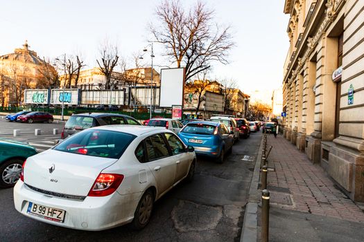 Car traffic at rush hour in downtown area of the city. Car pollution, traffic jam in the morning and evening in the capital city of Bucharest, Romania, 2020