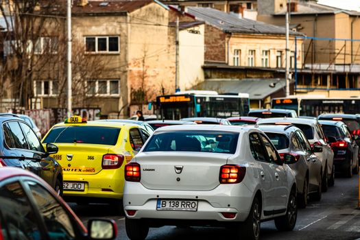 Car traffic at rush hour in downtown area of the city. Car pollution, traffic jam in the morning and evening in the capital city of Bucharest, Romania, 2020