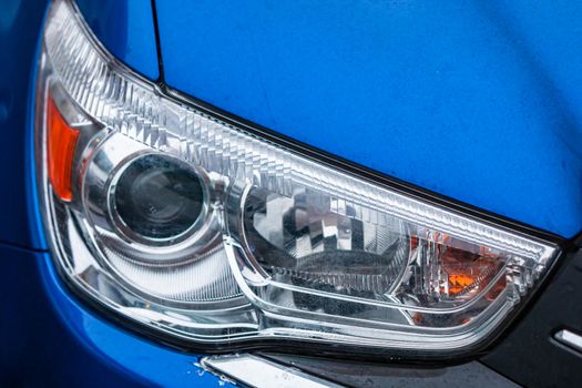 Close up photo of modern car, detail of headlight. Headlight car Projector LED of a modern luxury technology and auto detail.