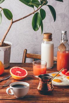 Healthy breakfast with turkish coffee, milk, juice, fried eggs, fruits and vegetables