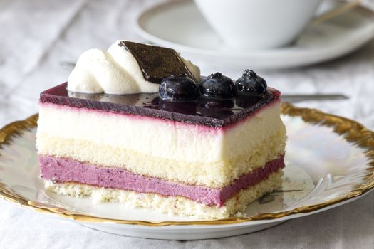 blueberry cake and a cappucino