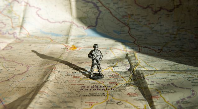 A figurine of an armed soldier on the map of Nagorno-Karabakh.