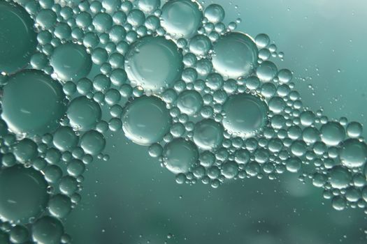 abstract macro background of oil circles floating over water surface . Macro closeup view of bubbles on water . oil bubbles in the water macro photographic background