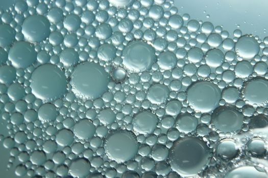 abstract macro background of oil circles floating over water surface . Macro closeup view of bubbles on water . oil bubbles in the water macro photographic background