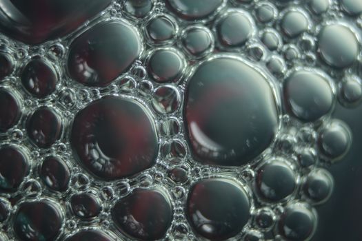 abstract macro background of oil circles floating over water surface . Macro closeup view of bubbles on water . oil bubbles in the water macro photographic background