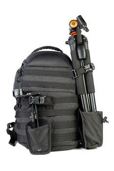 Black professional tactical molle black photo backpack with tripod and panoramic head isolated on white background.