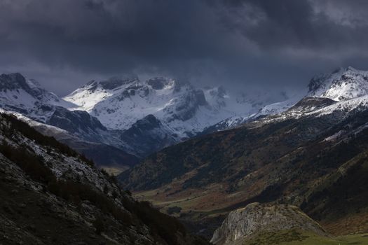 Snowy mountains landscape in the Aragonese Pyrenees. Cloudy view of the Guarrinza pastures, near of Aguas Tuertas valley, Hecho and Anso, Huesca, Spain.