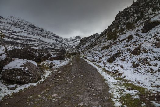 Snowy mountains in the Aragonese Pyrenees. Path from Guarrinza pastures to Aguas Tuertas valley, Hecho and Anso, Huesca, Spain.