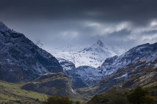 Snowy mountains landscape in the Aragonese Pyrenees. View of the Guarrinza pastures, near the Barcal ravine, in the direction of Aguas Tuertas, near Hecho and Anso, Huesca, Spain.