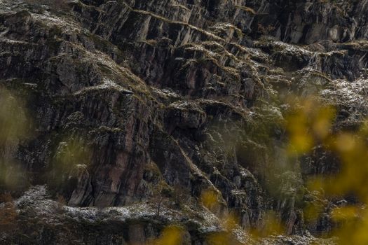 Steep walls of dark rock, slightly covered with snow. Aragonese Pyrenees. Hecho and Anso, Huesca, Spain.