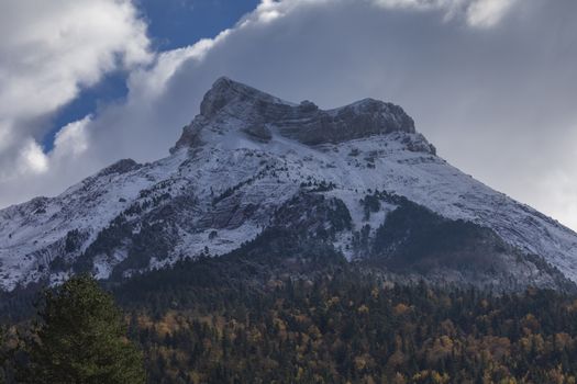 Snowy Castillo de Acher mountain, surrounded by beech and coniferous forest, is 2384 meters high and is located in the Selva de Oza area, in the western part of the Aragonese Pyrenees, Huesca, Spain.