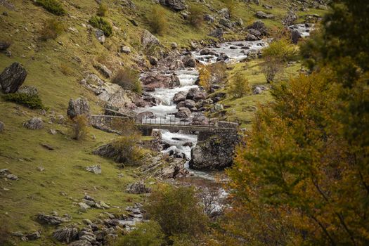 A bridge crossing the Aragon Subordan River, near its source. Aragonese Pyrenees, near of Aguas Tuertas valley, Hecho and Anso, Huesca, Spain.