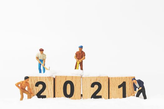 Miniature people : Worker team create wooden block number 2021  , Happy new year concept