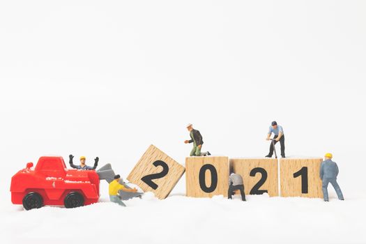 Miniature people : Worker team create wooden block number 2021  , Happy new year concept