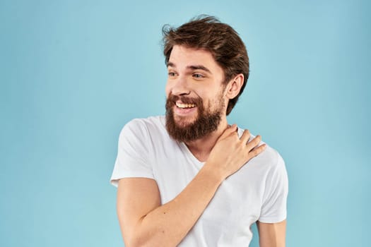 Cheerful man gesturing with his hands emotions cropped view on blue background studio. High quality photo