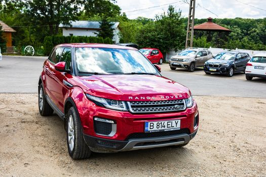 Shiny red Range Rover car in a parking lot in Bucharest, Romania, 2020