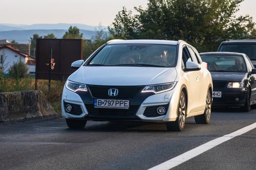 Traveling Honda car in motion on asphalt road, front view of car on street. Bucharest, Romania, 2020