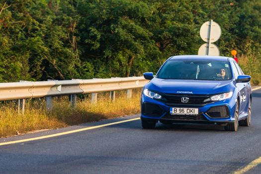 Traveling Honda car in motion on asphalt road, front view of car on street. Bucharest, Romania, 2020