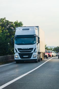 Loaded European truck in motion on asphalt road, transportation and delivery concept. Bucharest, Romania, 2020