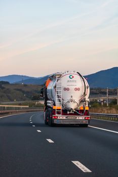 Back view of loaded European truck in motion on asphalt road, transportation and delivery concept. Bucharest, Romania, 2020