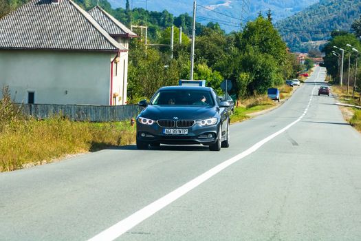 Traveling BMW car in motion on asphalt road, front view of car on street. Bucharest, Romania, 2020