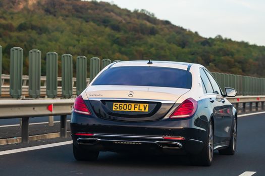 Traveling Mercedes car in motion on asphalt road, back view of car on street. Bucharest, Romania, 2020