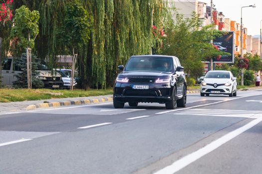 Traveling car in motion on asphalt road, front view of car on street. Bucharest, Romania, 2020