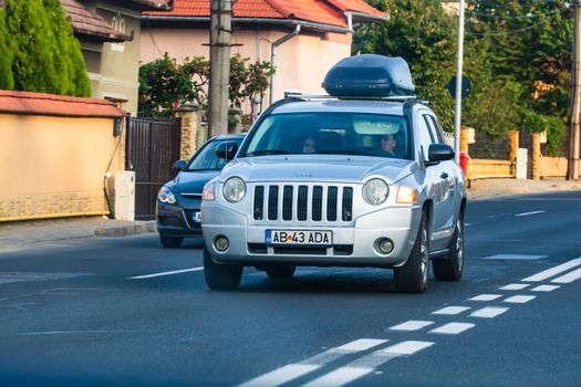 Traveling JEEP car in motion on asphalt road, front view of car on street. Bucharest, Romania, 2020