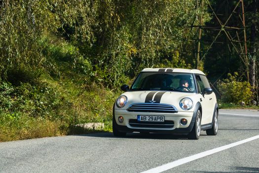 Traveling MINI car in motion on asphalt road, front view of car on street. Bucharest, Romania, 2020